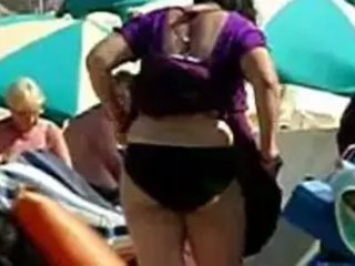 Auntie in bikini unclothes down on a